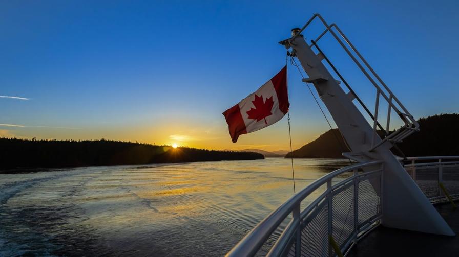 canadian flag boat sunset
