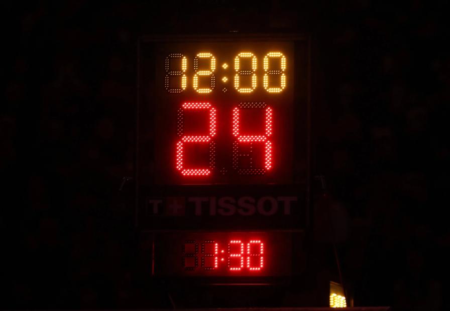 A digital shot clock displaying 12:00 in yellow and 24 in red against a dark background.