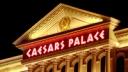 Illuminated Caesars Palace sign on the Roman-style facade of the Las Vegas hotel and casino at night.