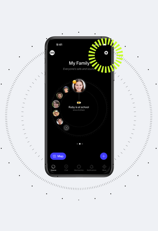 Black smartphone displaying a "My Family" app with Ruby's location marked "at school," on a gray background with a radar-like pattern and a vibrant green segmented circle overlay.