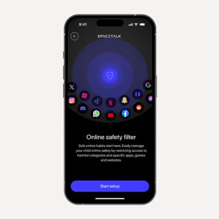 Smartphone showing the SPACETALK app's "Online safety filter" setup, with a central blue shield icon surrounded by various social media and streaming app logos, and text explaining parental controls.