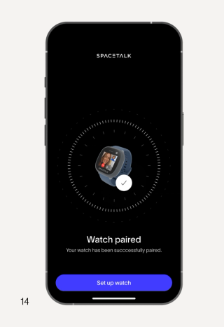 A smartphone displays the SpaceTalk app, showing a blue smartwatch with a checkmark and the text "Watch paired" and a "Set up watch" button.