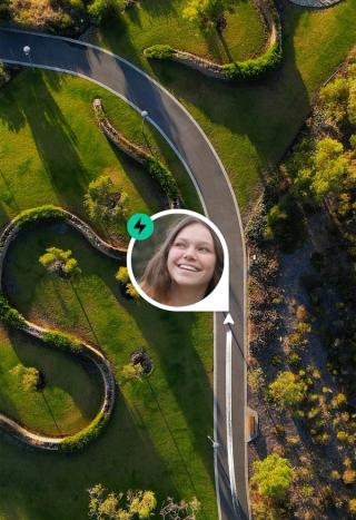 A smiling woman's profile picture with a lightning bolt icon placed over an aerial view of a winding park path, with an arrow indicating movement along the path.
