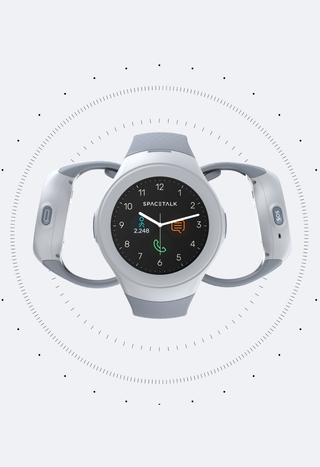 A white and grey SPACETALK smartwatch with a circular screen showing time, step count, message, and call icons. It has outward-curving arms with "0" and "SOS" buttons.