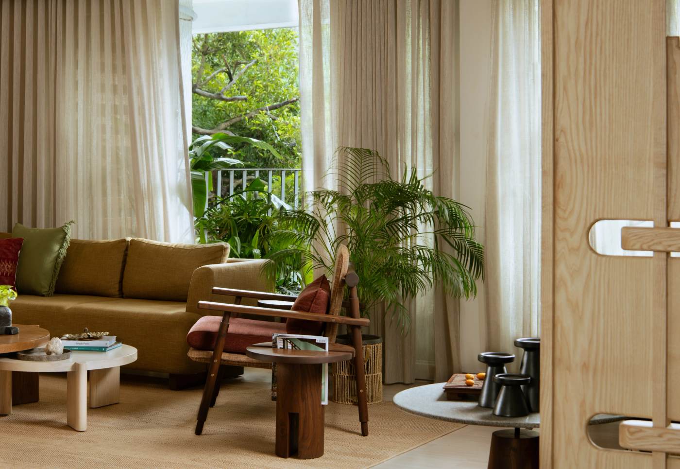 The living room seating, opening to the trees beyond