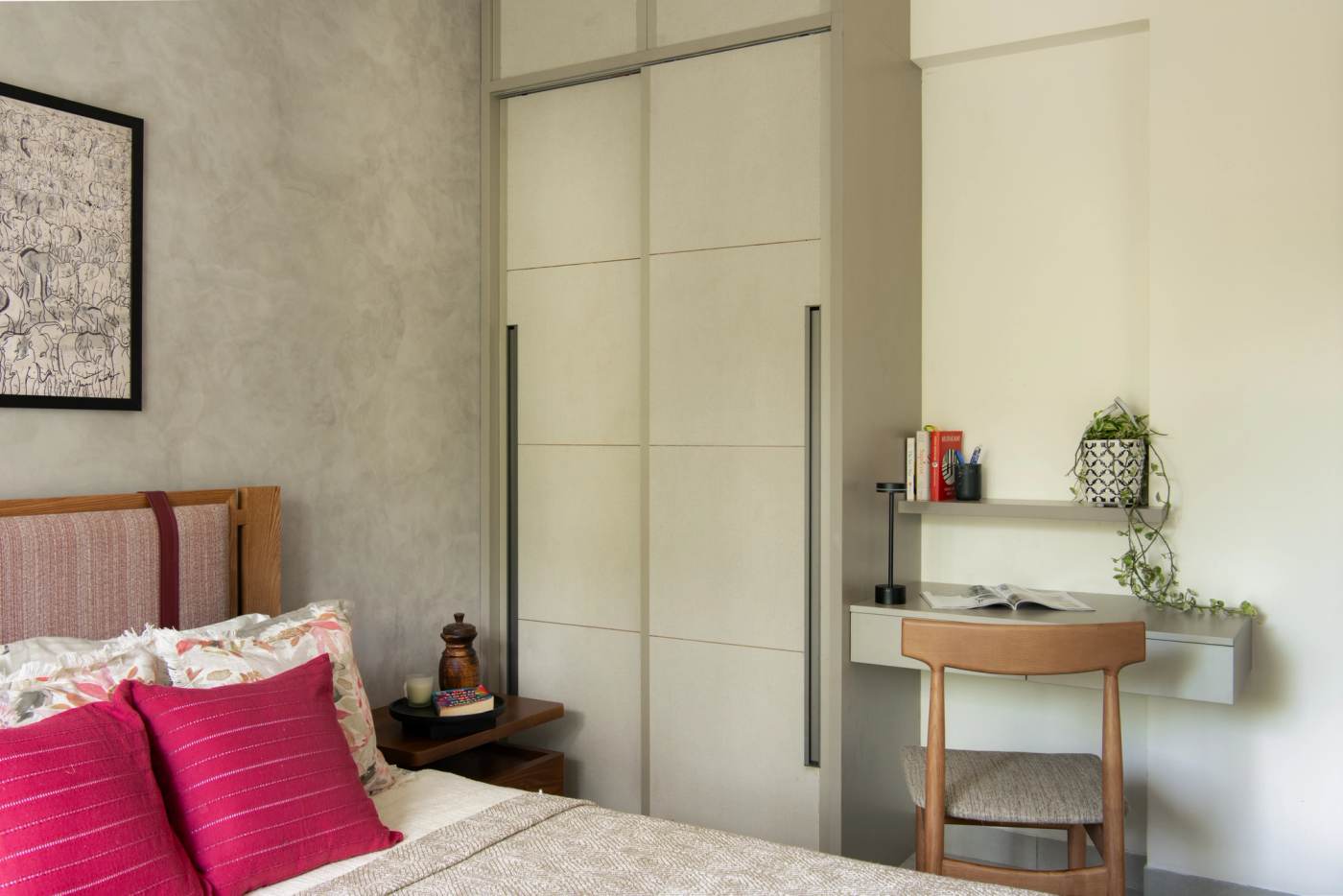 A bedroom with its wall-hung writing desk and sliding wardrobe