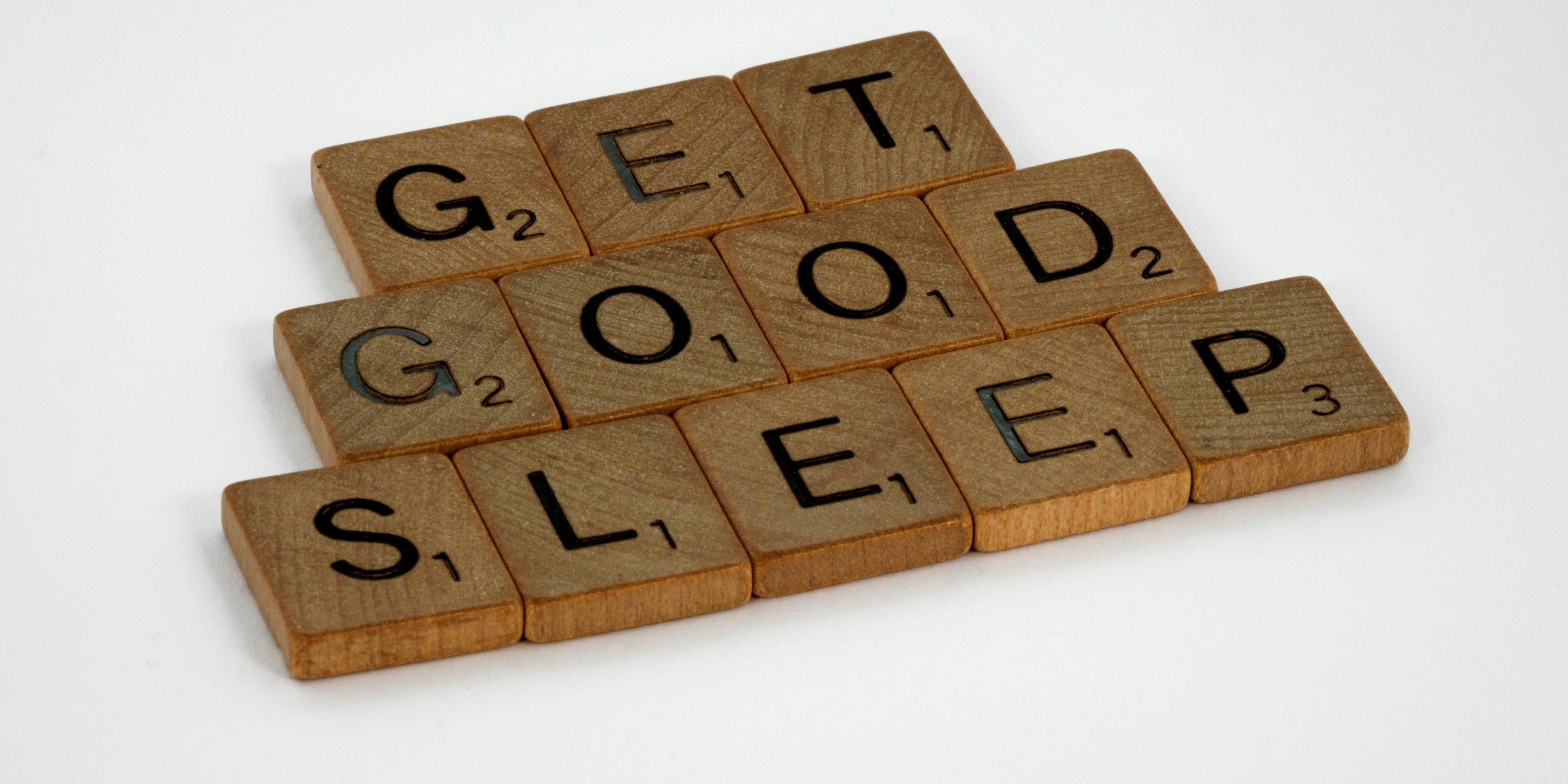 the words `` get good sleep '' are written on wooden scrabble tiles .