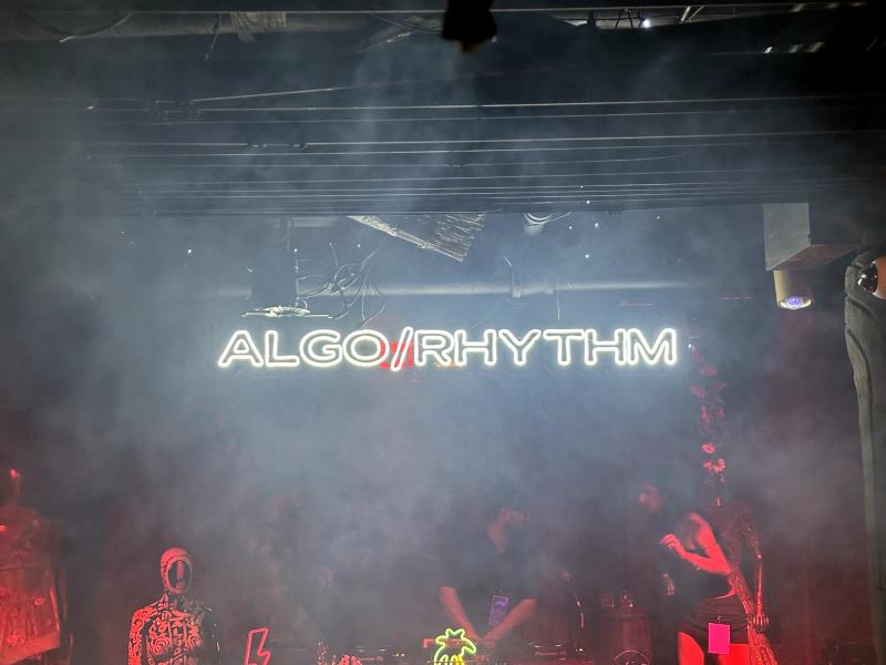 LED sign glowing above a crowded stage at a live event