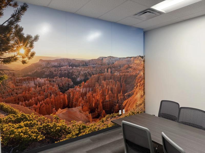 Close view of a floor-to-ceiling Bryce Canyon sunrise mural printed on wall vinyl in a small office meeting room