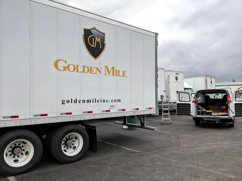 Golden Mile crest and lettering on a white dry van trailer