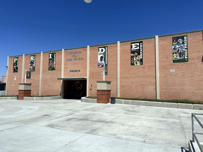 Vertical spirit banners installed across a brick high-school building