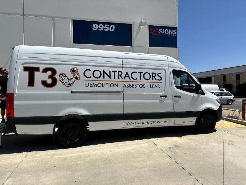T3 Contractors demolition-abatement lettering and logos on a white Sprinter van outside the VE Signs shop