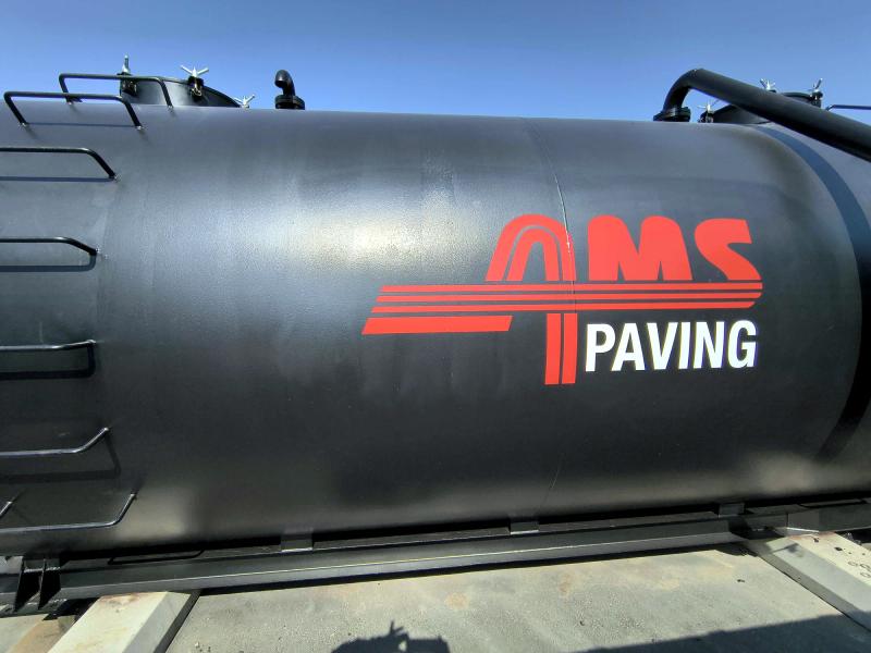 Black pneumatic tanker trailer with AMS Paving branding