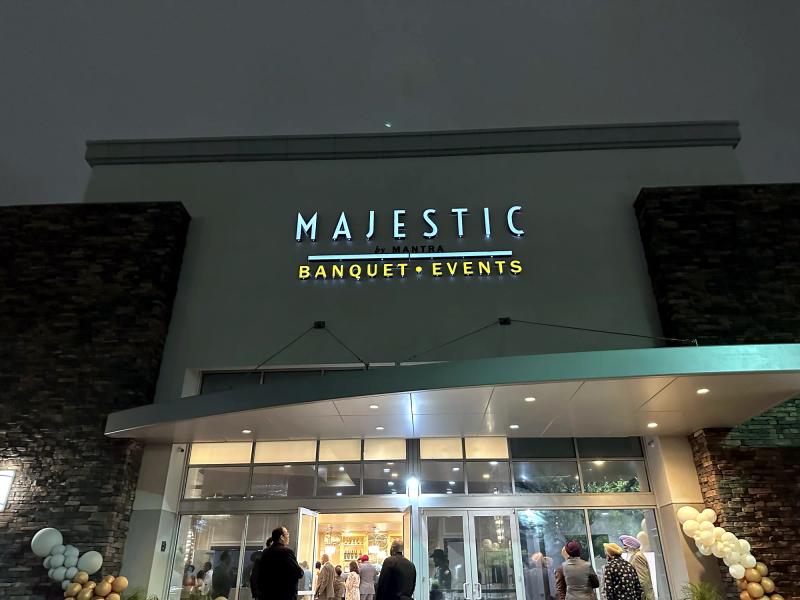 Reverse (halo) lit channel letters glowing at night over the entrance of Majestic Banquet + Events
