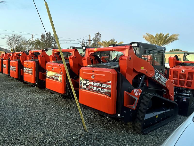 Row of orange track loaders with C5 Equipment Rentals decals