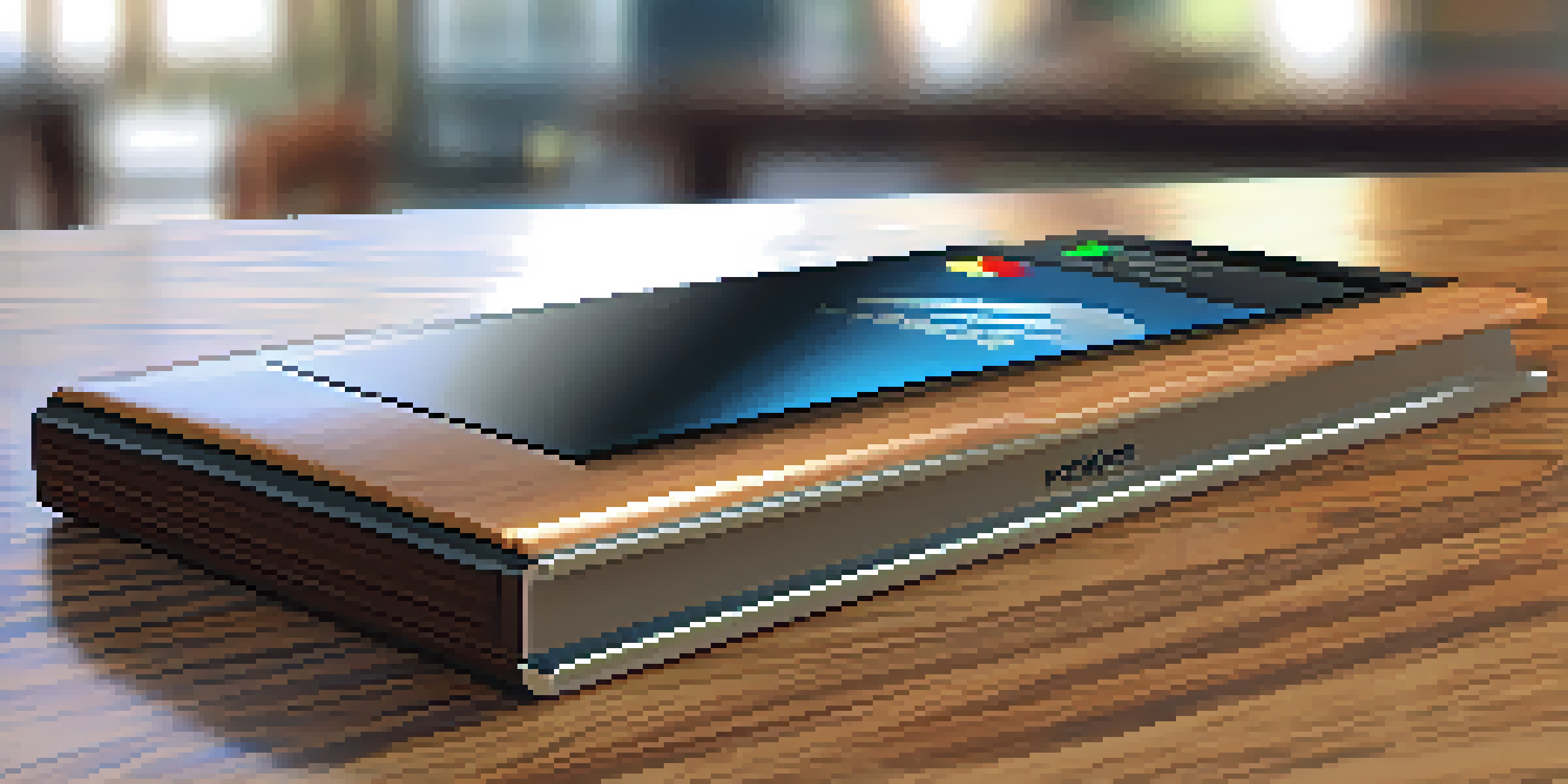 A close-up of a hardware wallet on a wooden table with a secure login interface on the screen.