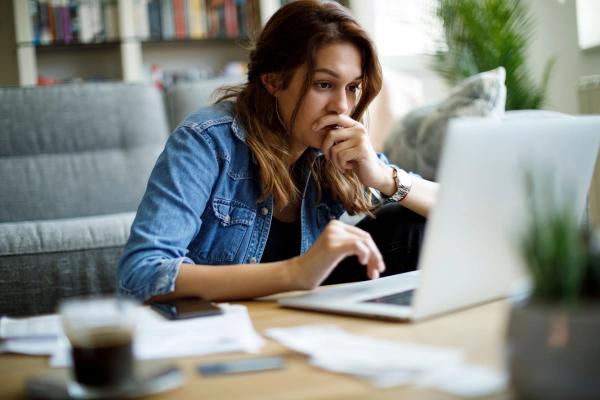 Woman appearing stressed looking at her computer