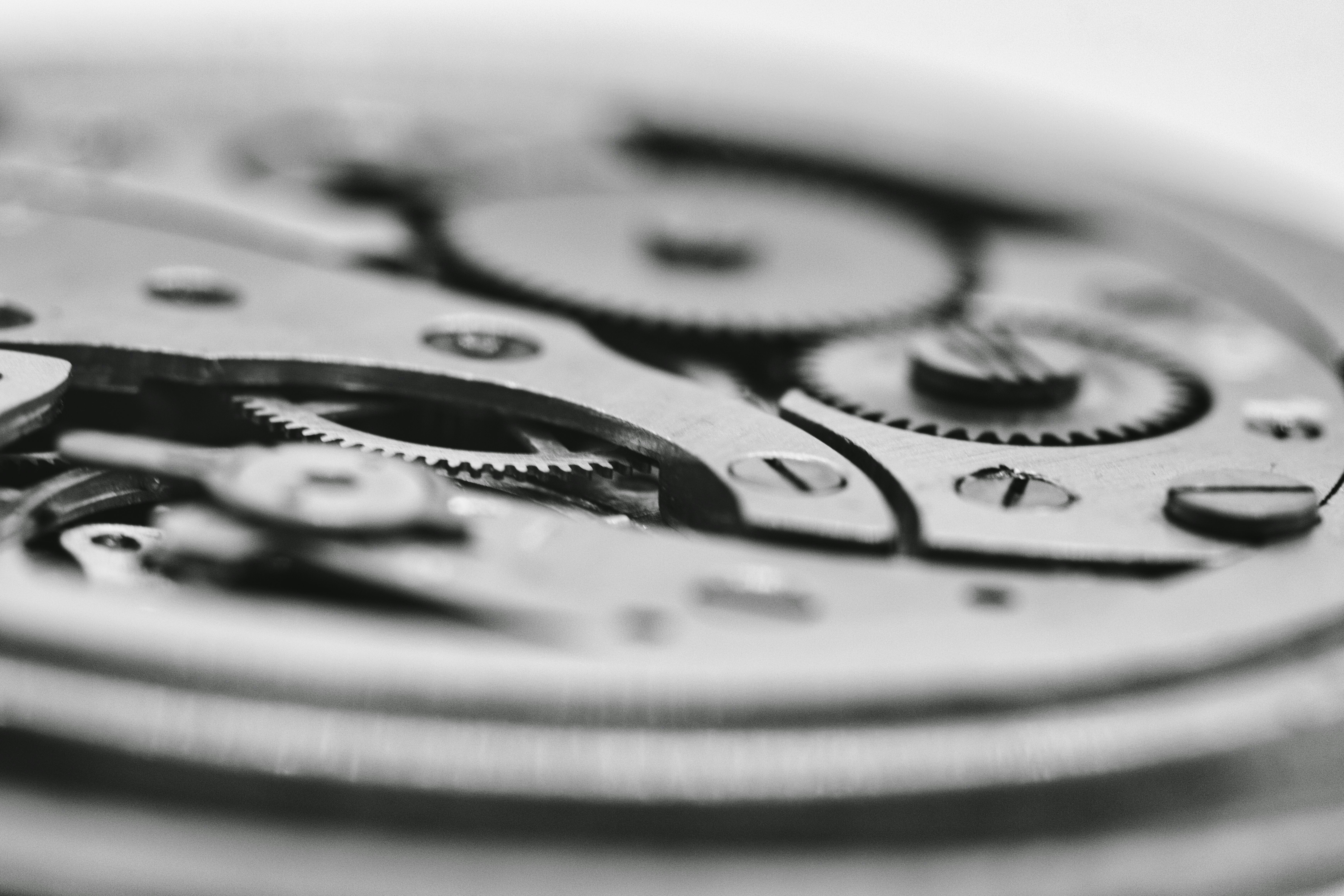 Exposed mechanical watch movement without a dial, symbolizing headless software run by AI agents