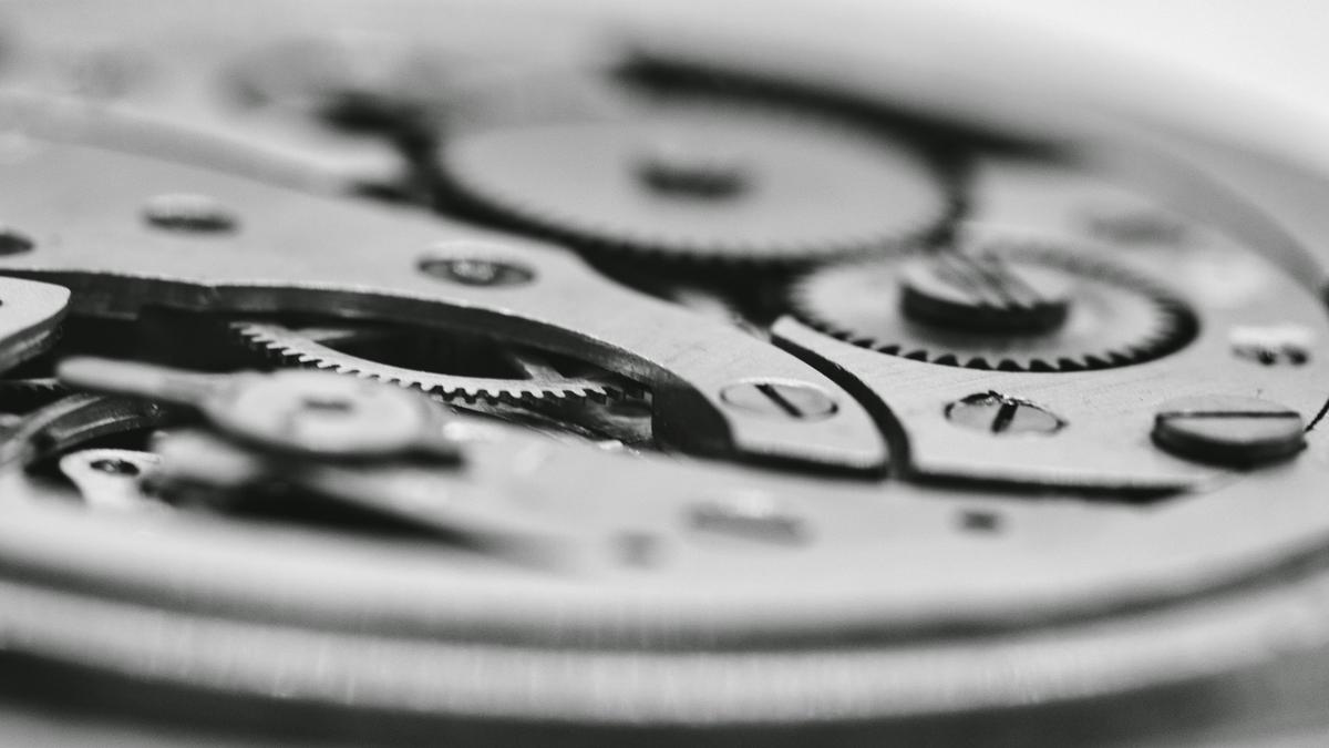 Exposed mechanical watch movement without a dial, symbolizing headless software run by AI agents