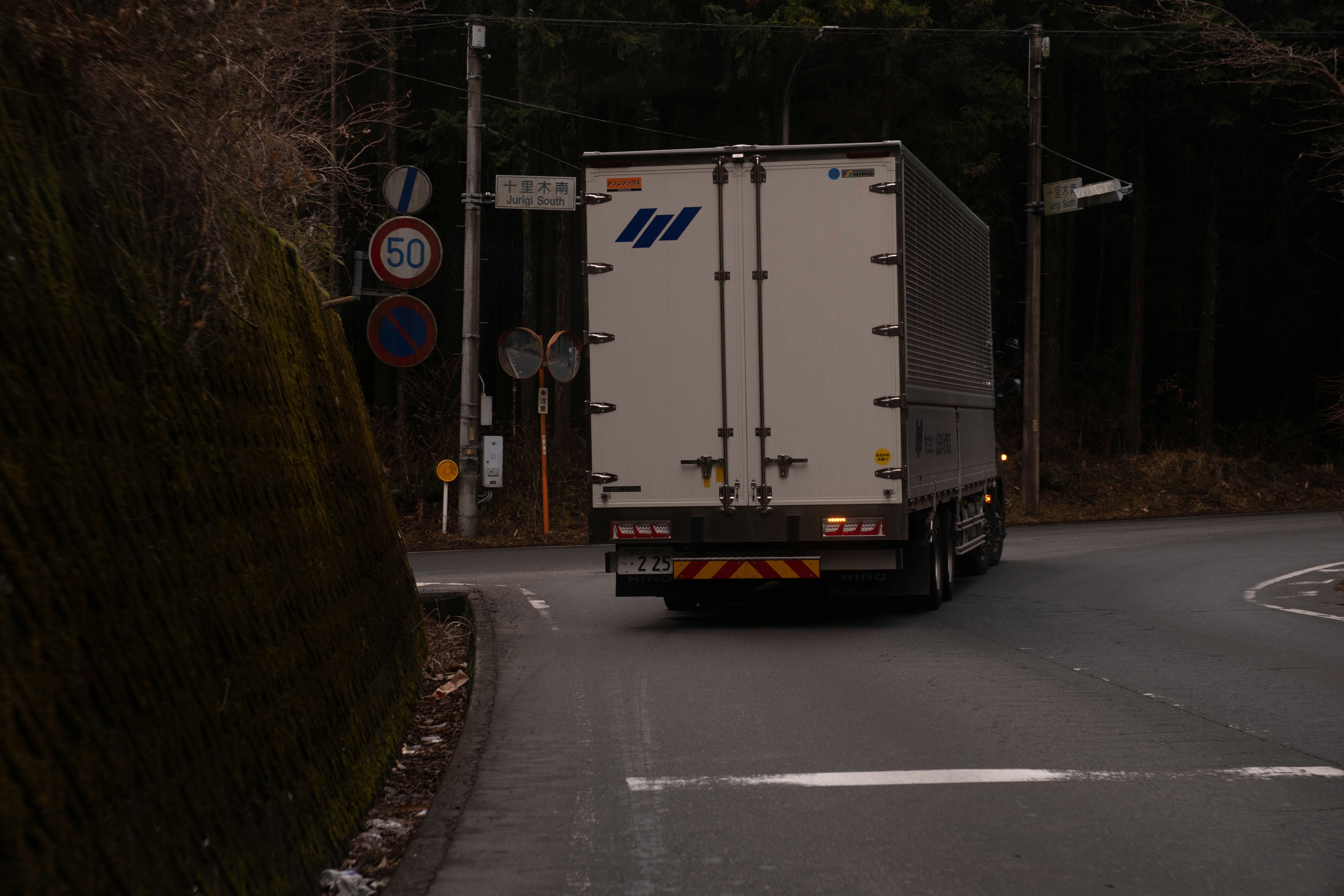 Large truck on a narrow winding road, an image for cutting AI costs through the right model choice