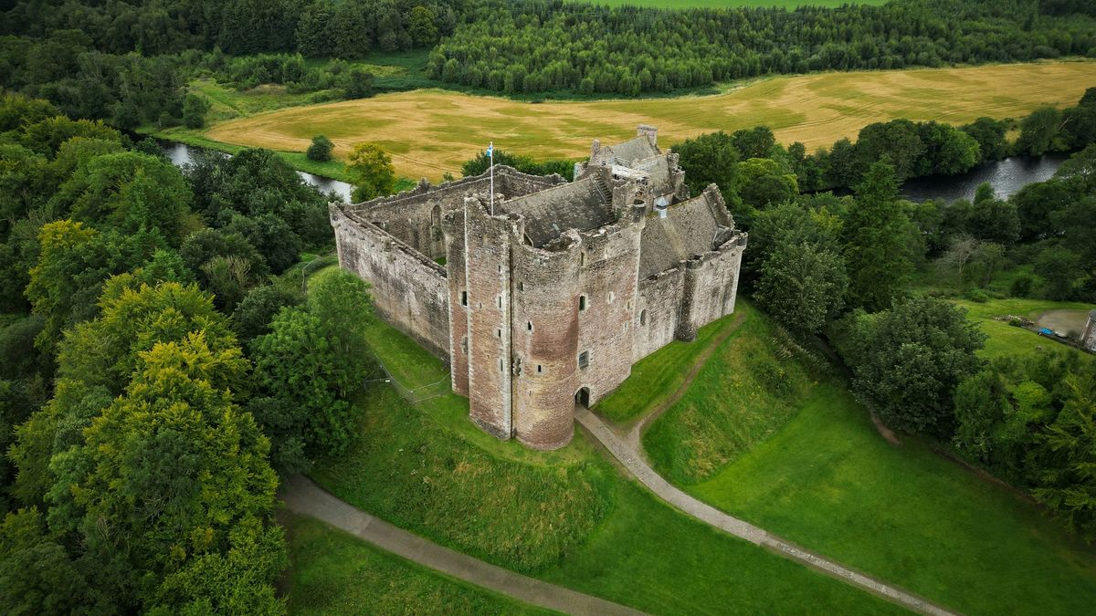 Aerial view of a medieval castle ringed by a river moat, a picture of a defensible B2B SaaS business model and its competitive moat.