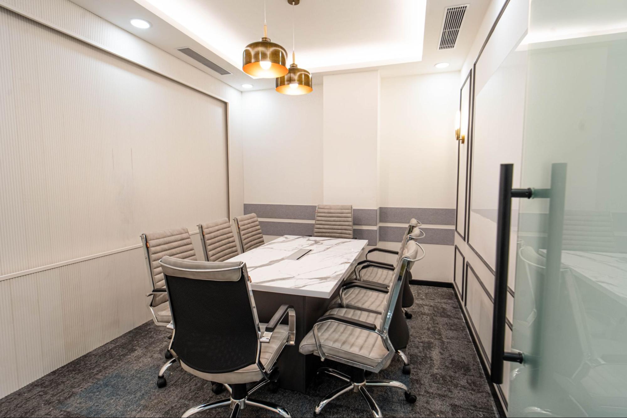 Meeting room with a marble-top table, grey leather chairs and brass pendant lights, AIHP SCO 34, Sector 32 Gurgaon