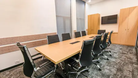Ten-seat meeting room with a wood table, black leather chairs and a wall-mounted screen, AIHP SCO 31, Sector 32 Gurgaon