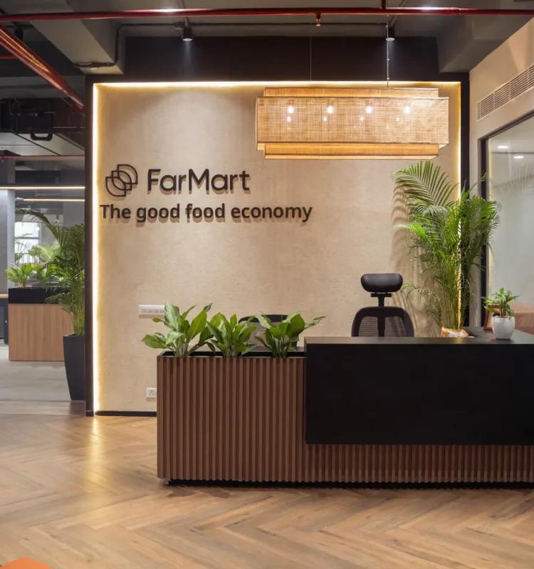 FarMart-branded reception with planters and rattan pendant light, AIHP Cyber Greens, Udyog Vihar Gurgaon