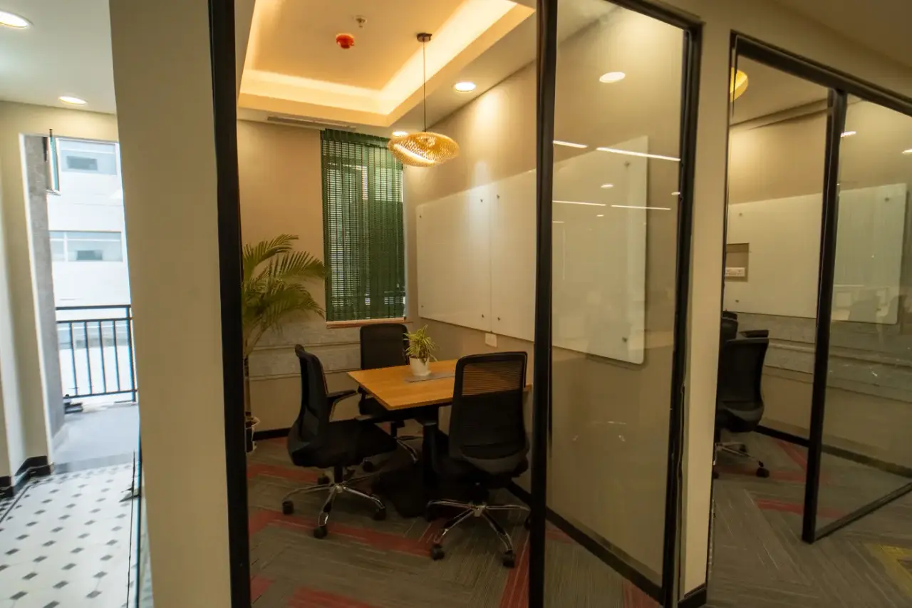 AIHP Atrium row of private glass-fronted office cabins overlooking the city, Sector 32, Gurgaon