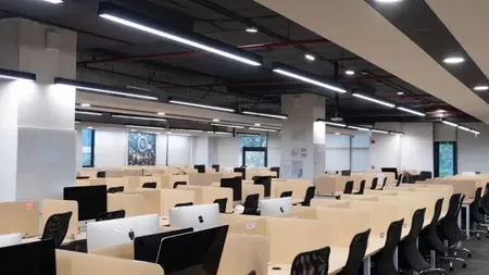 Open-plan workstation floor with rows of desks and computer monitors at AIHP Horizon