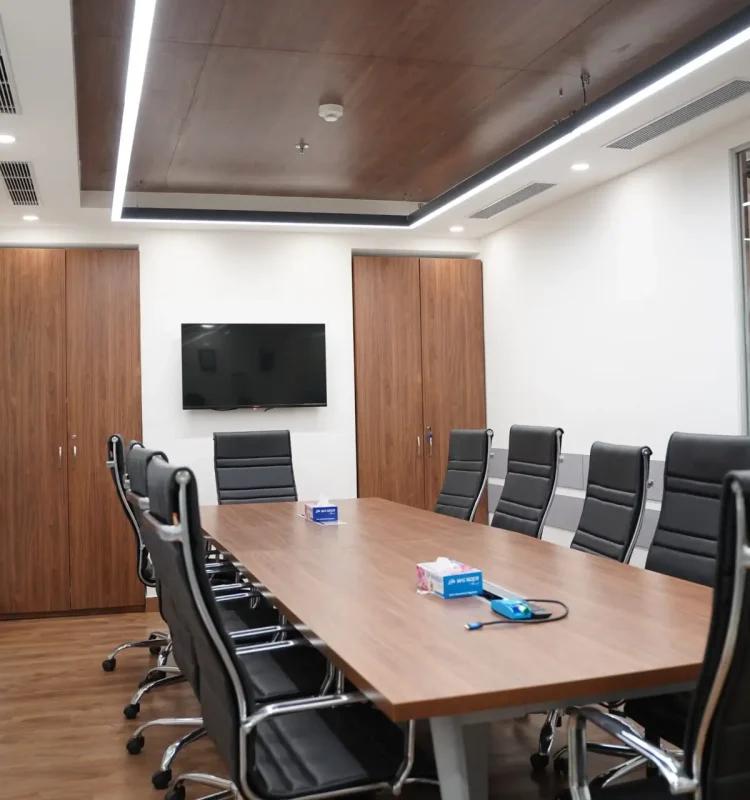 Ten-seat boardroom with walnut table, leather chairs and wall TV, AIHP Cyber Greens, Udyog Vihar Gurgaon