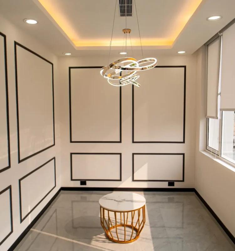 Panelled breakout lounge with a round marble table and pendant light at AIHP SCO 27