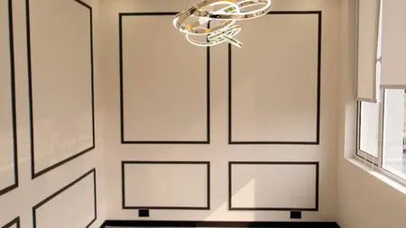 Panelled breakout lounge with a round marble table and pendant light at AIHP SCO 27