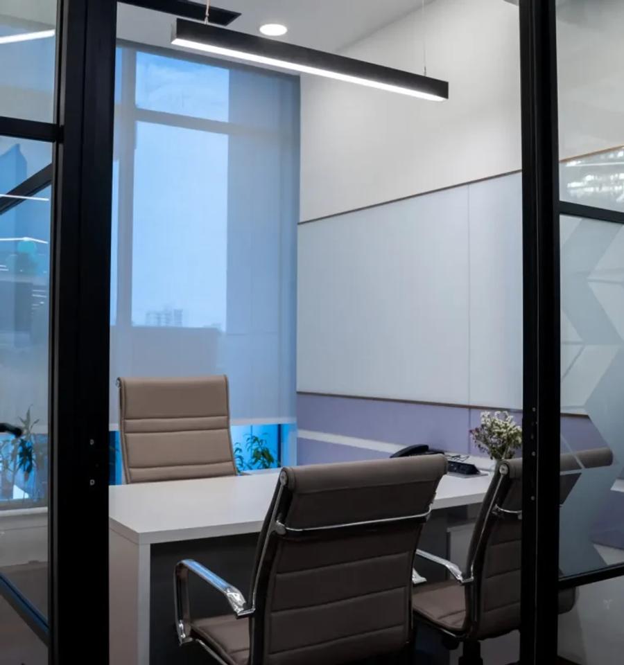 Glass-walled private cabin with executive desk at an AIHP Sector 32 office, Gurgaon