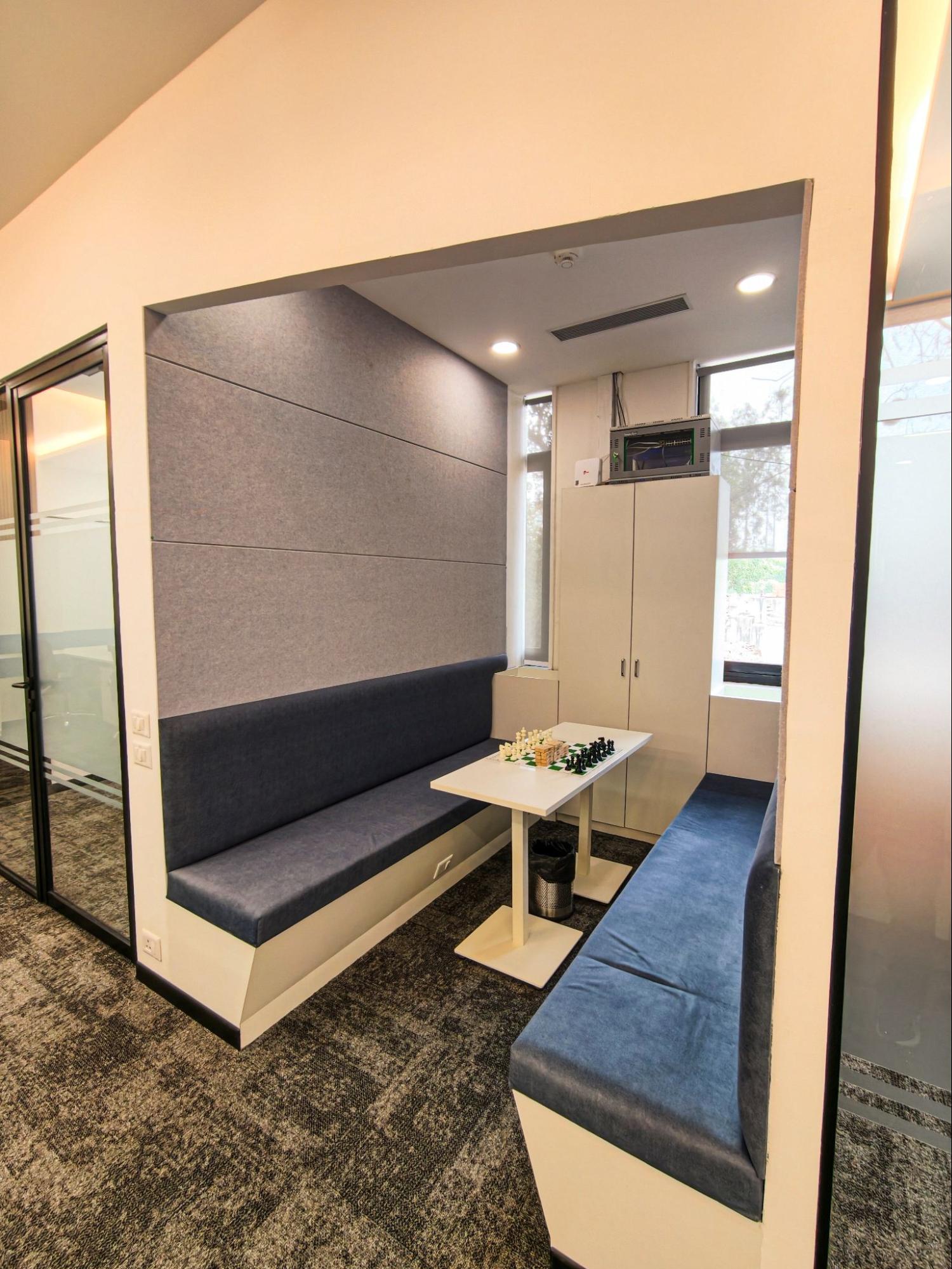 Breakout booth with navy bench seating and a small table, AIHP SCO 31, Sector 32 Gurgaon