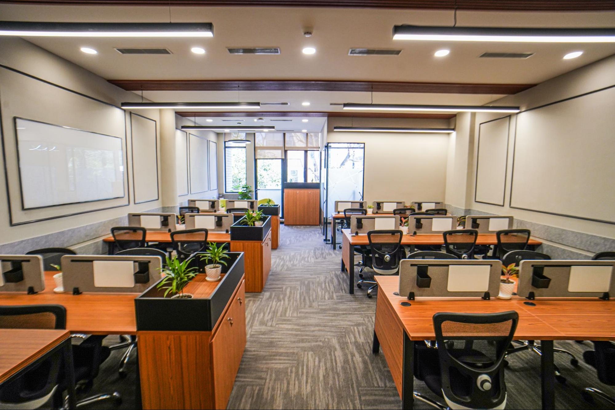 Open-plan workstations with planter dividers and mesh chairs, AIHP SCO 34, Sector 32 Gurgaon