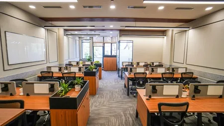 Open-plan workstations with planter dividers and mesh chairs, AIHP SCO 34, Sector 32 Gurgaon