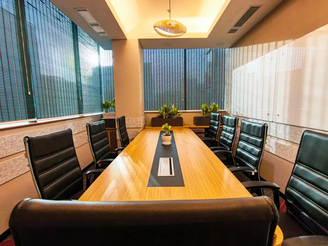 AIHP Atrium executive boardroom with a long wood conference table and panoramic Gurgaon city views