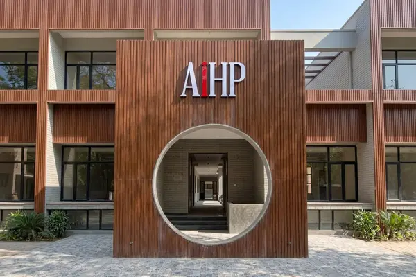 AIHP SCO 29B facade with wood-slat cladding and a circular entrance arch, Sector 32 Gurgaon