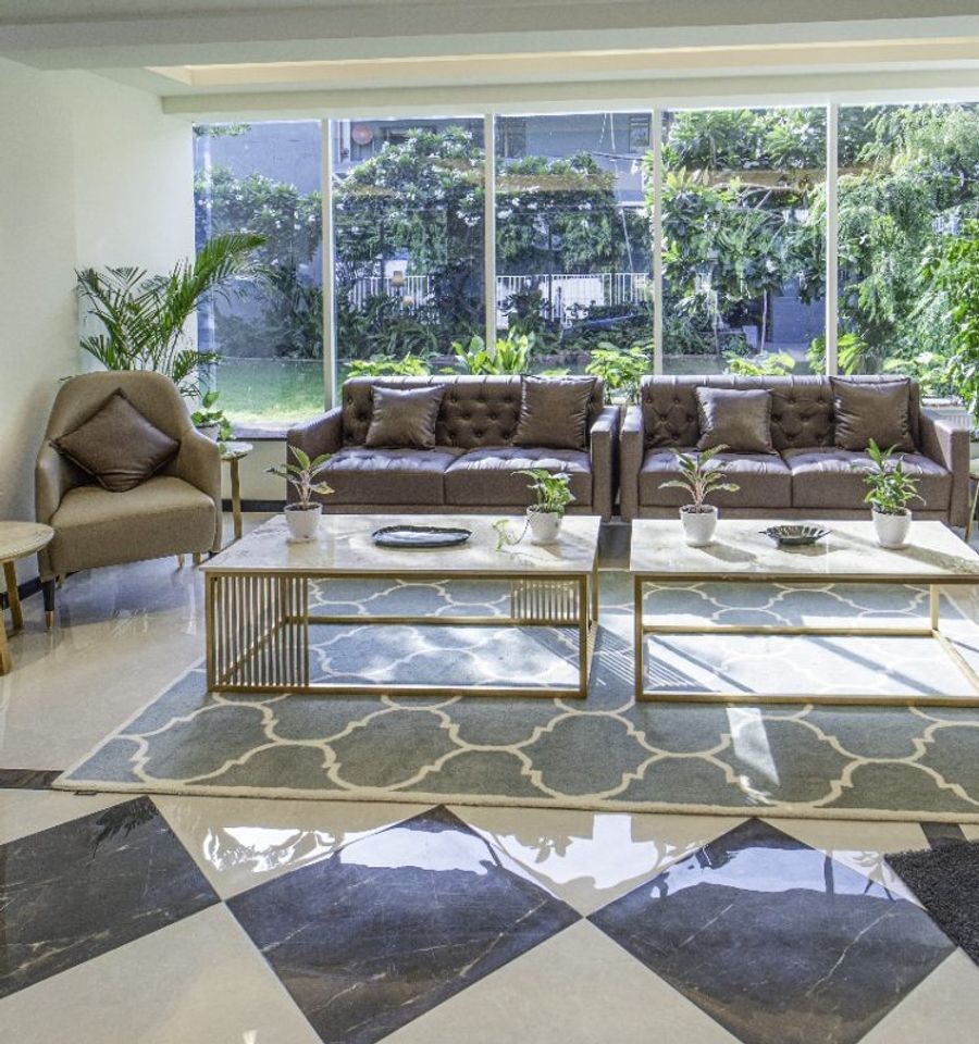 Breakout lounge beside garden-facing glazing at AIHP Cyber Greens 2