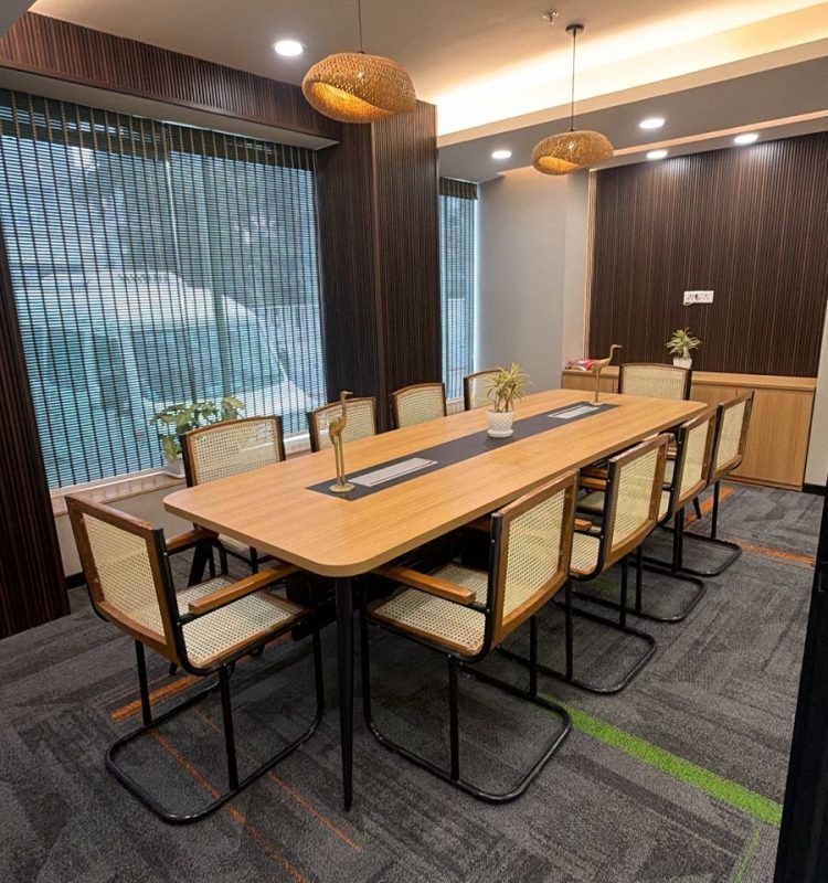 Glass-walled meeting room with a solid-wood table at AIHP Cyber Greens 2
