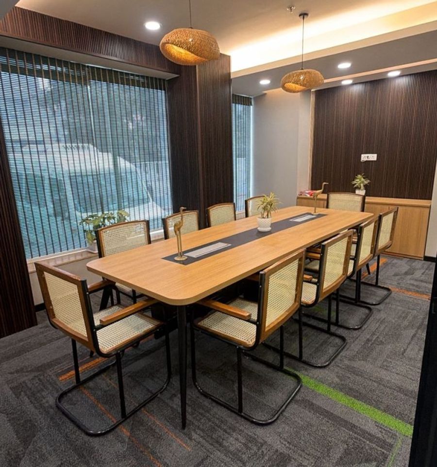Glass-walled meeting room with a solid-wood table at AIHP Cyber Greens 2