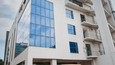 Exterior facade of AIHP Broadway building with glass windows and balconies