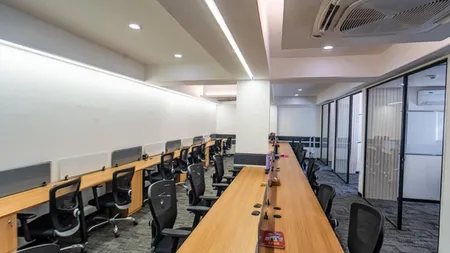 Open-plan bench workstations with mesh chairs and glass cabins, AIHP SCO 29B, Sector 32 Gurgaon