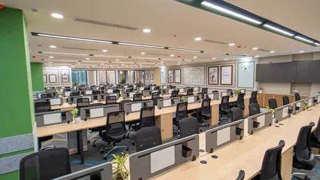 Open workstation area at AIHP Spectra with framed wall art and a green accent column