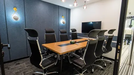 Meeting room with a wood table, navy panelled walls and glass pendant lights, AIHP SCO 29B, Sector 32 Gurgaon
