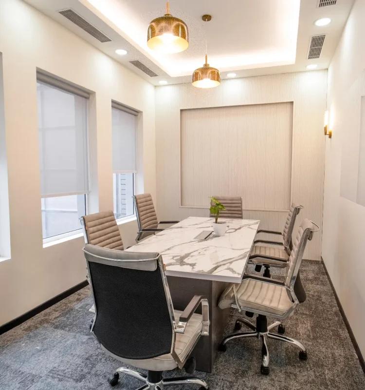 Six-seat meeting room with marble-top table and brass dome pendant lights, AIHP SCO 27, Sector 32 Gurgaon