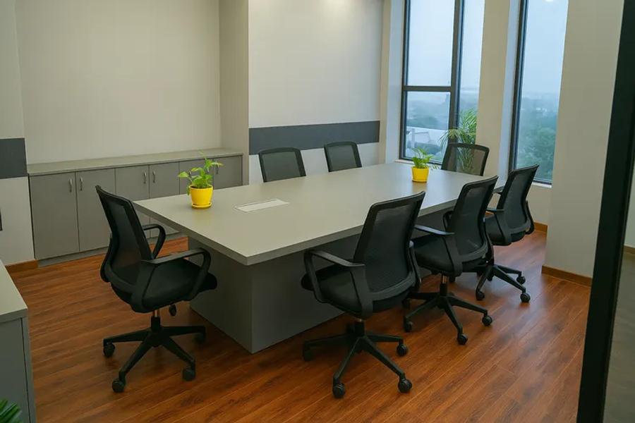 Conference room with city-view windows at an AIHP Sector 32 office, Gurgaon