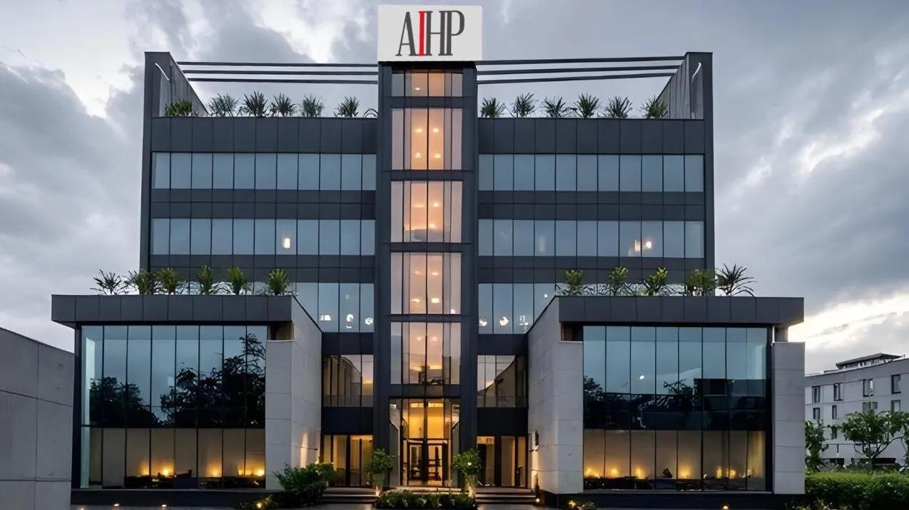 AIHP One Grade-A office tower facade at dusk, Golf Course Extension Road, Gurgaon