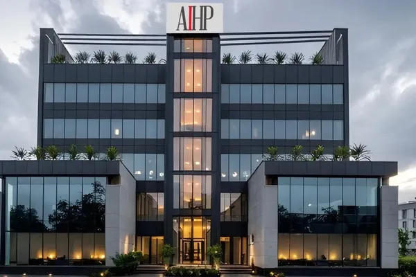 AIHP One Grade-A office tower facade at dusk, Golf Course Extension Road, Gurgaon